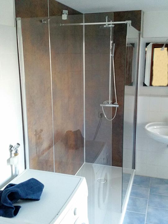 Eine große begehbare Dusche, fugenlose Wandflächen von der Dusche bis unter die Decke